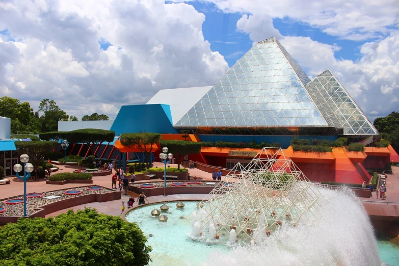 a large building with a fountain in front of it, hypermodernism, epcot, a brightly colored, pyramids, usa-sep 20