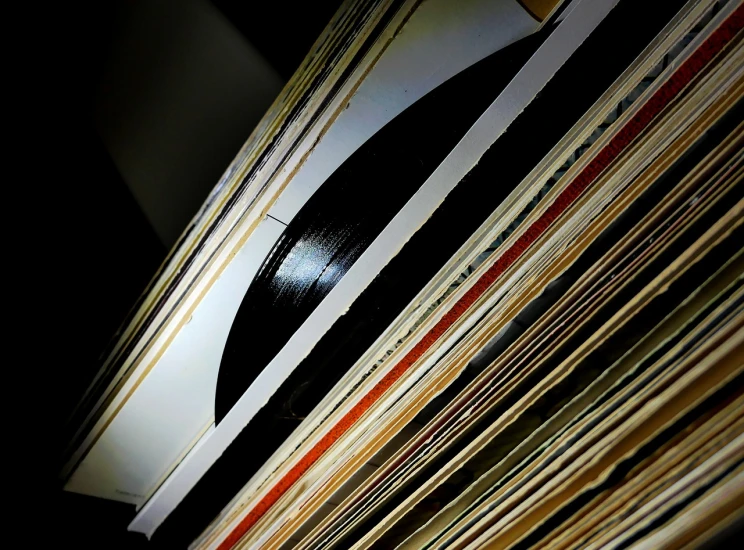 a stack of vinyl records sitting on top of a table, a picture, by Thomas Häfner, flickr, worm's eye view from floor, backlighted, seventies, stems