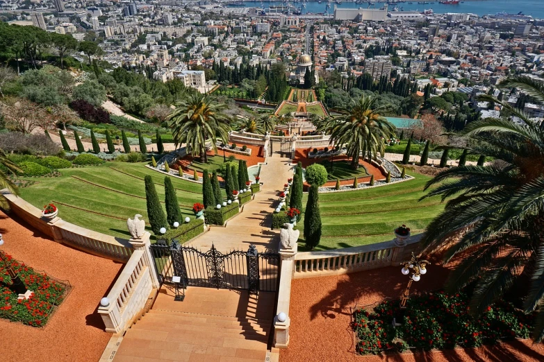 a view of the city from the top of a hill, by Douglas Shuler, pexels, art nouveau, in red gardens, hebrew, with palm trees and columns, gardens with flower beds