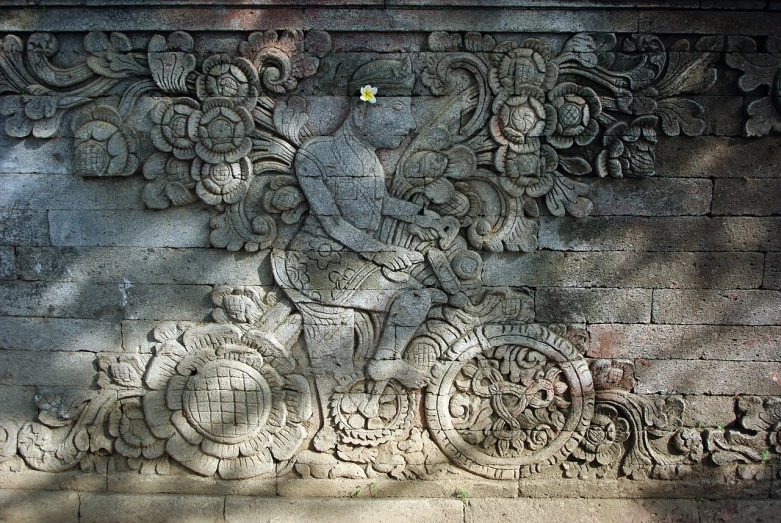 a close up of a stone carving on a wall, by I Ketut Soki, flickr, carrying flowers, riding, carved floor, very detailed ”