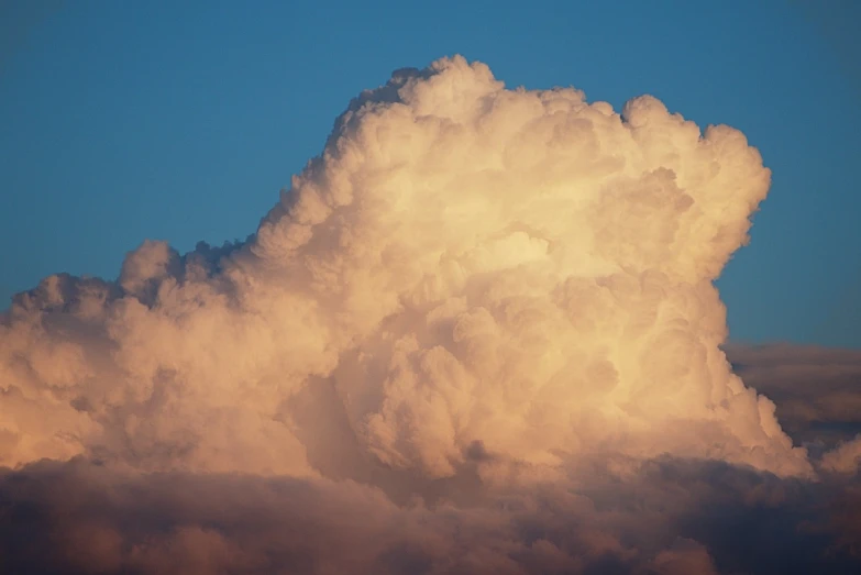 a plane flying through a cloud filled sky, a picture, by Jan Rustem, romanticism, giant cumulonimbus cloud, at the golden hour, cloud hair, cloud in the shape of a dragon