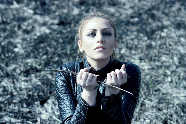 a woman in a black leather jacket holding a knife, inspired by irakli nadar, antipodeans, nature outside, twigs, lady gaga, beautiful iranian woman
