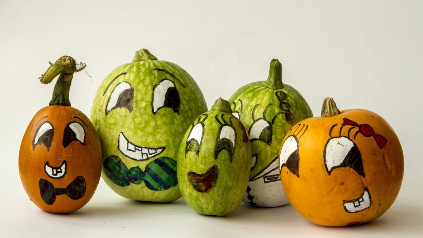 a group of pumpkins with faces painted on them, a pastel, by Maksimilijan Vanka, green head, family photo, photo taken on a nikon, sprites