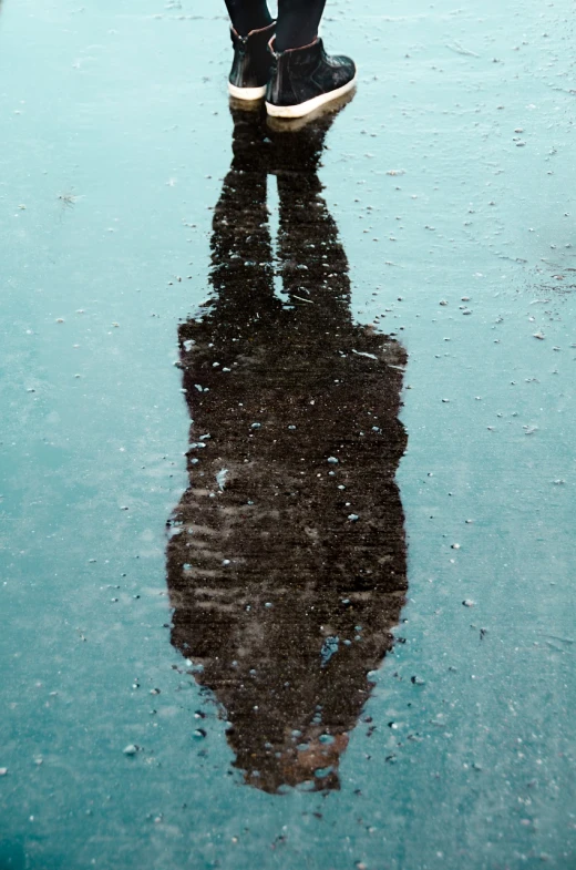 a person standing in the rain with an umbrella, by Jan Rustem, minimalism, detailed reflection, crystallized human silhouette, boston, upside down
