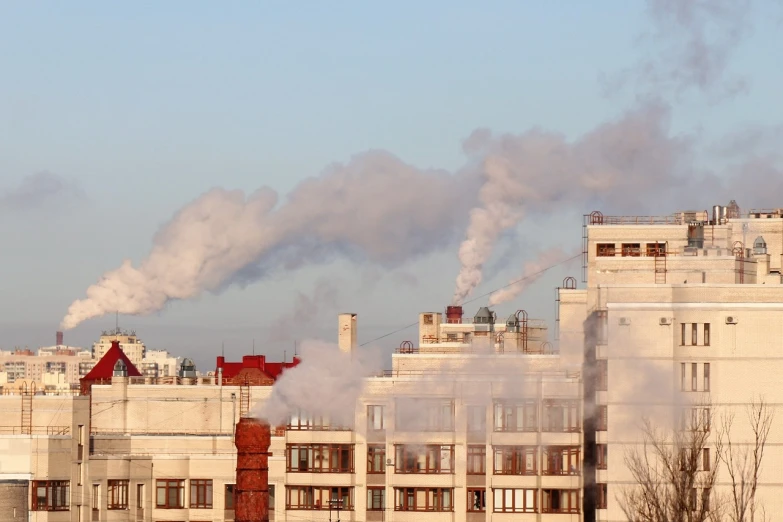 a building with a lot of smoke coming out of it, a picture, shutterstock, chimneys on buildings, rostov, morning detail, 2 0 2 2 photo