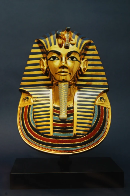 a golden mask sitting on top of a wooden stand, egyptian art, by John Atherton, cg society contest winner, hurufiyya, inlaid with gold, god emperor of dune, -h 1024, full head shot
