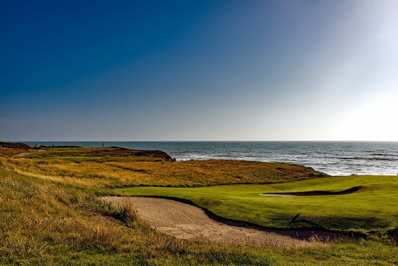 a golf course overlooking the ocean on a sunny day, by Raymond Normand, shutterstock, high quality photo, american west scenery, epic composition 8 5 mm, prairie