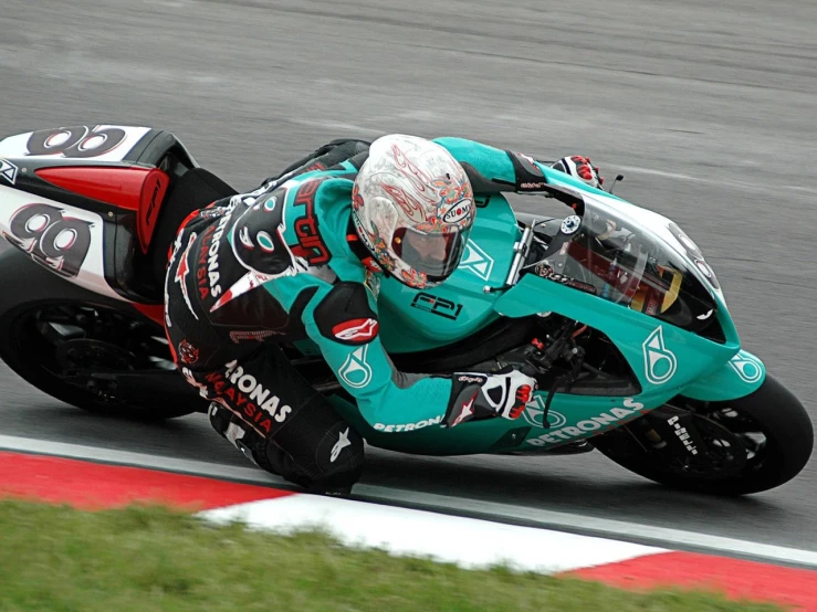 a person riding a motorcycle on a race track, inspired by Cam Sykes, flickr, teal uniform, malaysian, on flickr in 2007, black+velvet+red+turquoise