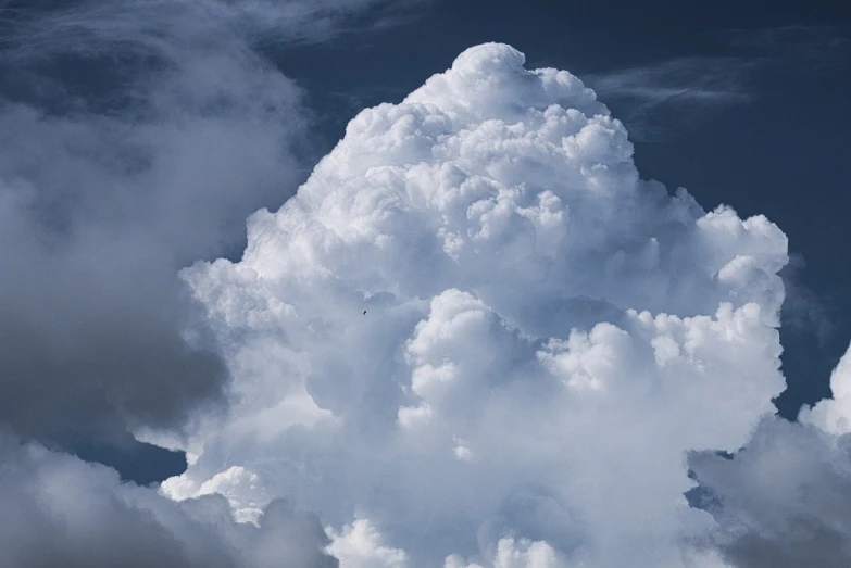 a plane flying through a cloud filled sky, a picture, by Jan Rustem, giant cumulonimbus cloud, sitting in a fluffy cloud, profile image, looking upwards