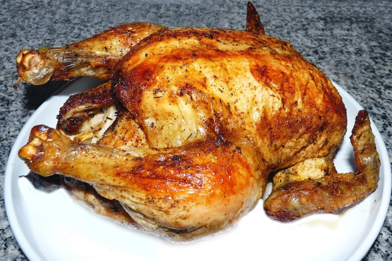a chicken sitting on top of a white plate, pixabay, hurufiyya, oven, glistering!!! oiled - skin!!!, very very very highly detailed, jamaican