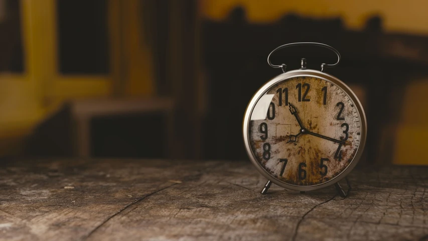 a clock sitting on top of a wooden table, happening, looking old, hyperrealistic, fim still, realistically