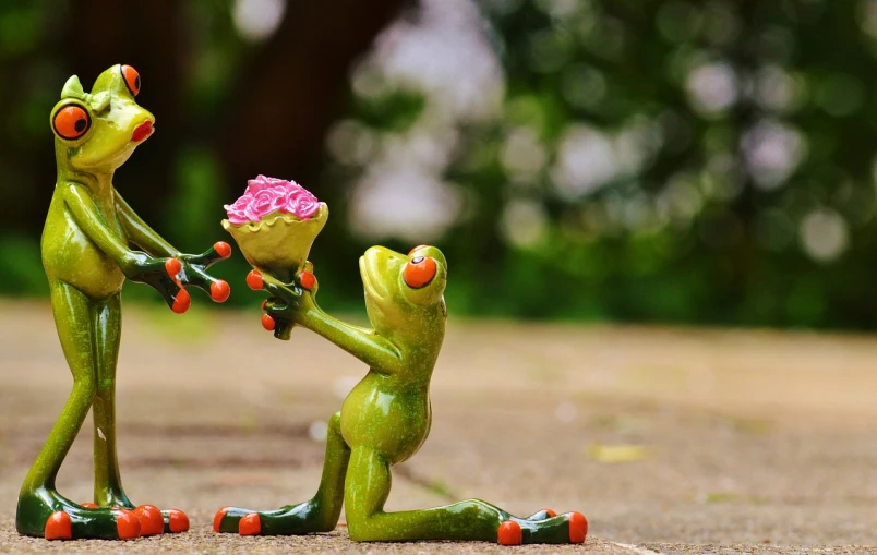 a figurine of a frog giving a flower to another frog, pixabay contest winner, romanticism, holding a rose, on his hind legs, 🌸 🌼 💮, lascivious pose