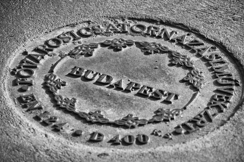 a black and white photo of a fire hydrant, an engraving, by Adam Szentpétery, concrete art, budapest, sundial, medallion, cryptonomicon