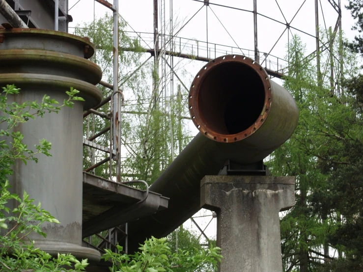 a large pipe sitting in the middle of a forest, a picture, by Henryka Beyer, flickr, bauhaus, chemical plant, detail structure, in an abandoned theme park, high details photo