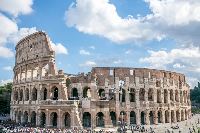 a crowd of people standing in front of the colossion, by Tom Wänerstrand, pexels contest winner, neoclassicism, colosseo, wide panoramic shot, beautiful sunny day, buildings carved out of stone