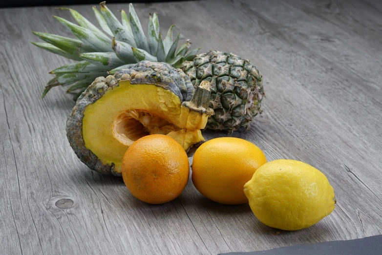 a pineapple and some oranges on a table, a still life, pexels, photorealism, photo 4 k, grey, highly detailed. post processing, wooden