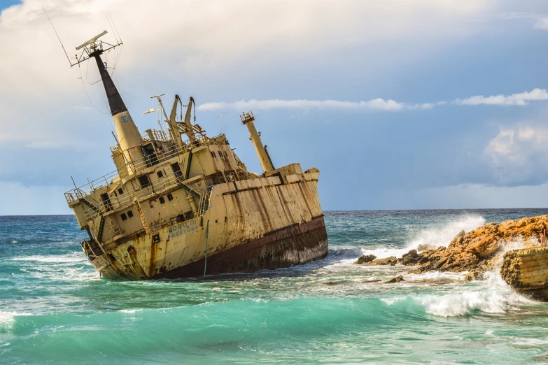 a large ship sitting on top of a body of water, by Richard Carline, shutterstock, washed up, kauai, terrifying but fascinating, demolition