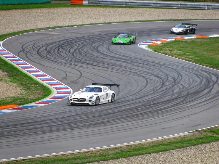 a couple of cars driving down a race track, by Hans Schwarz, flickr, spiralling, mercedes, markus vogt, foam