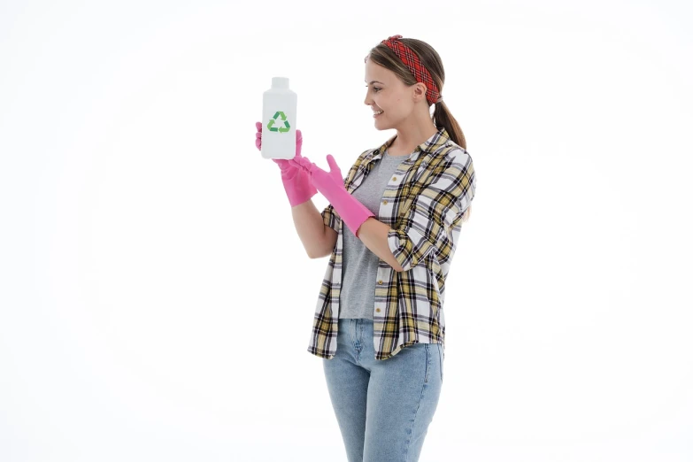 a woman in a plaid shirt holding a bottle of cleaner, a picture, plasticien, basic white background, pink girl, recycled, chemical substances