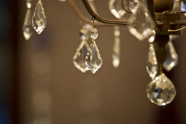 a chandelier with crystal drops hanging from it, a macro photograph, pexels, minimalism, well worn, subtle wear - and - tear, taken with canon 8 0 d, decorations