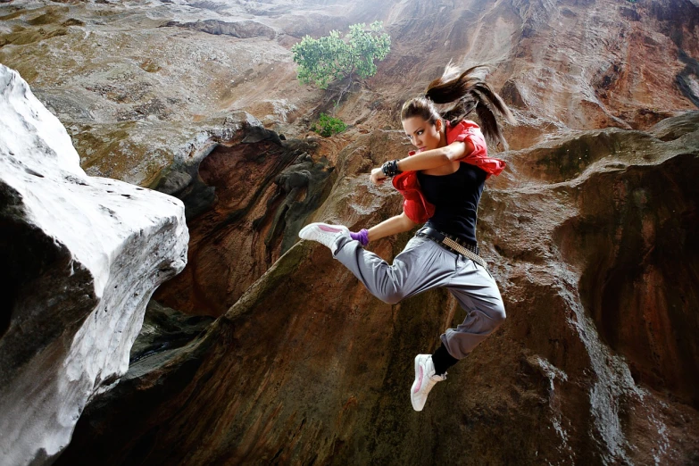 a couple of people that are jumping in the air, by Daryush Shokof, girl walking in a canyon, kung-fu, beautiful avatar pictures, very intense