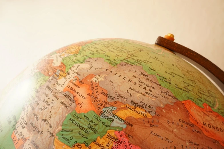a close up of a globe on a table, a tilt shift photo, mongolia, detailed zoom photo, high res photo, islamic
