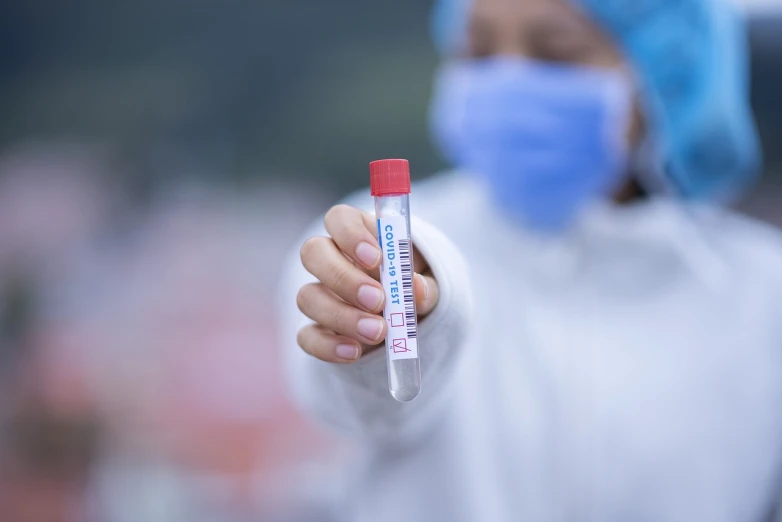 a close up of a person holding a tube of blood, a stock photo, blurred photo, no blur, covid-19 as a human, high temperature