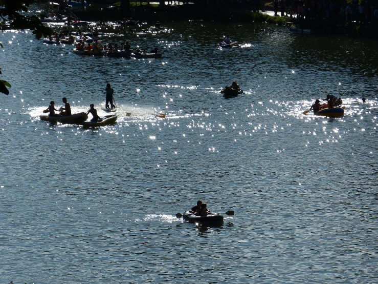 a number of people in small boats on a body of water, inspired by Thomas Eakins, flickr, sparkling in the sunlight, partly sunken! in the lake!, zoomed out, performance