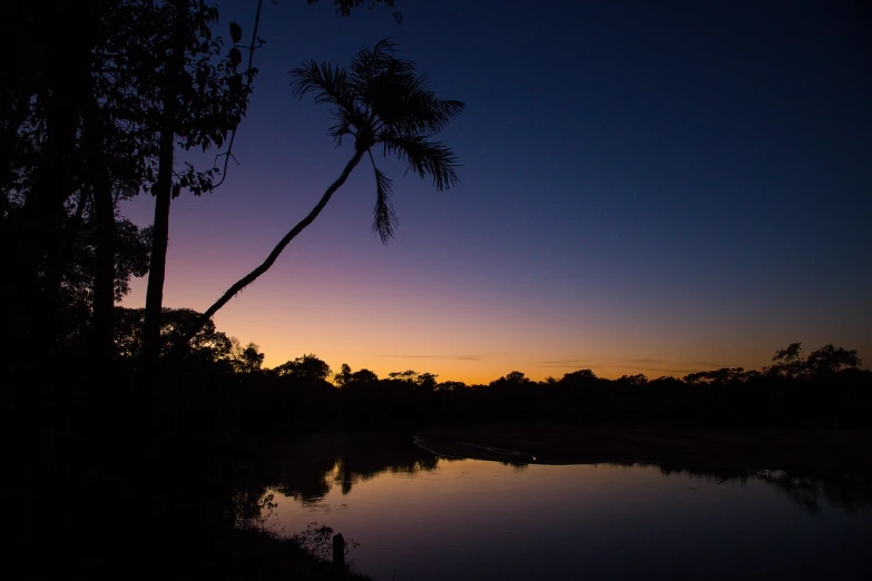 a boat sitting on top of a body of water, by Niklaus Manuel, flickr, hurufiyya, on jungle night !!!, violet and yellow sunset, photo 85mm, zac retz