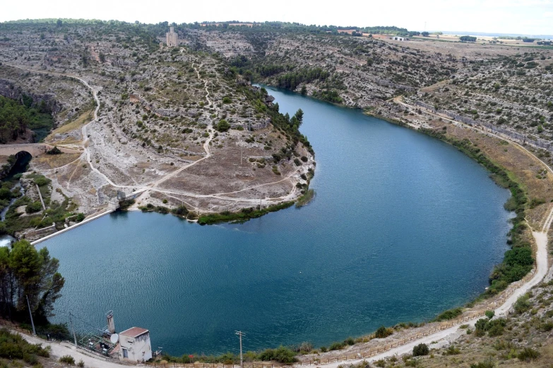 a large body of water sitting on top of a lush green hillside, by Altichiero, les nabis, rock quarry location, reyezuelo listado, !!highly detalied, can basdogan