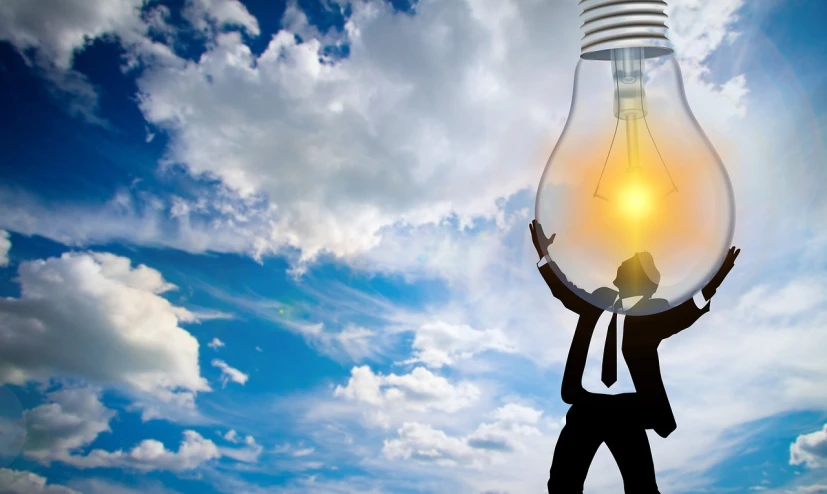 a man in a suit holding up a light bulb, a picture, by Elias Ravanetti, shutterstock, light and clouds, back lit, beautiful sunny day, artistic interpretation