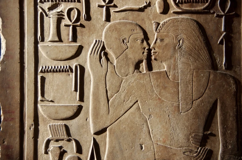 a close up of a carving on a wall, egyptian art, art deco, kissing, family, closeup photo, bald