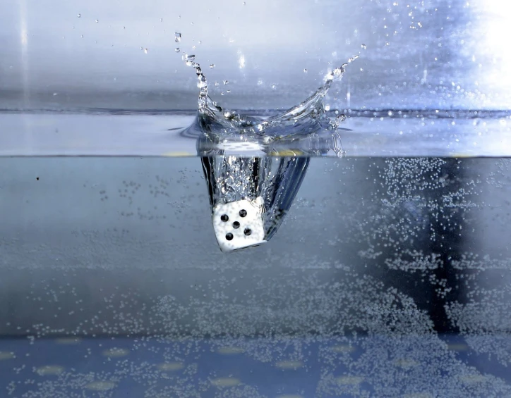 a dice falling into a pool of water, a picture, by Jon Coffelt, conceptual art, water-cooled, rain sensor, underwater shot, liquid polished metal