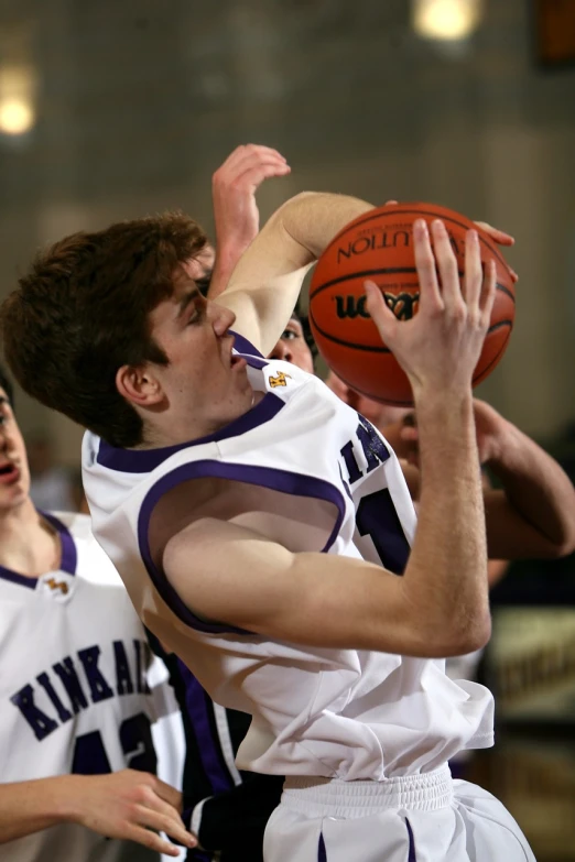a group of young men playing a game of basketball, a portrait, realism, subtle purple accents, getty images, panel, 1 / 4 headshot