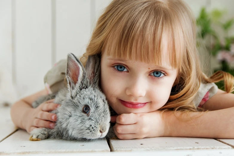 a little girl that is laying down with a bunny, a picture, by Martina Krupičková, shutterstock, fantastic realism, big grey blue eyes, hugging each other, karol bak uhd, photo of a beautiful