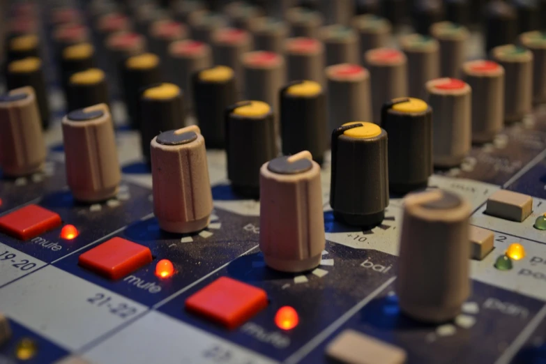 a close up of a sound board in a recording studio, a picture, by Alison Watt, shutterstock, depth detail, coloured, journalism photo, button potenciometers