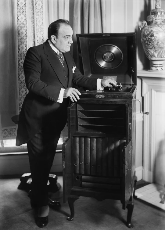 a black and white photo of a man in a suit, a stock photo, by Everett Warner, boombox, victor horta, james c, displayed