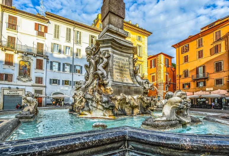 a fountain in the middle of a city with buildings in the background, by Carlo Martini, shutterstock, renaissance, 🕹️ 😎 🔫 🤖 🚬, sunken square, nice colors, an ancient