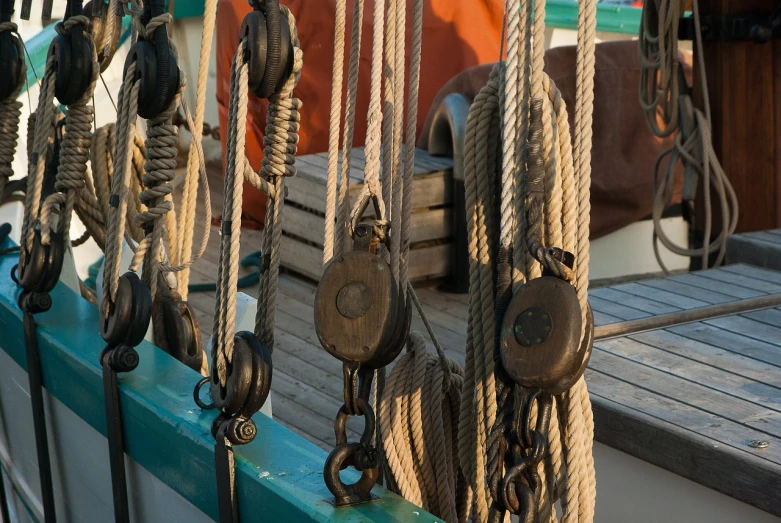 a close up of a bunch of ropes on a boat, by Richard Carline, sigma 1/6, cogs and wheels, nice afternoon lighting, 1 6 9 5