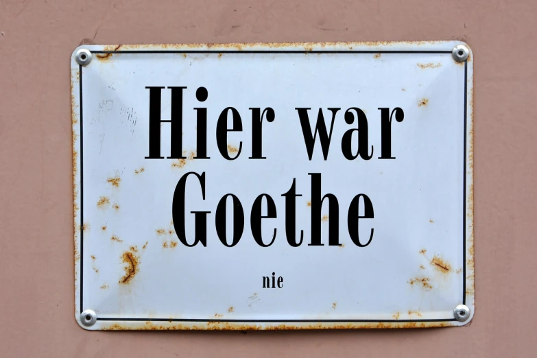 a close up of a sign on a wall, by Leo Goetz, shutterstock, german romanticism, war photo, hegre, we go, heavy vignette!