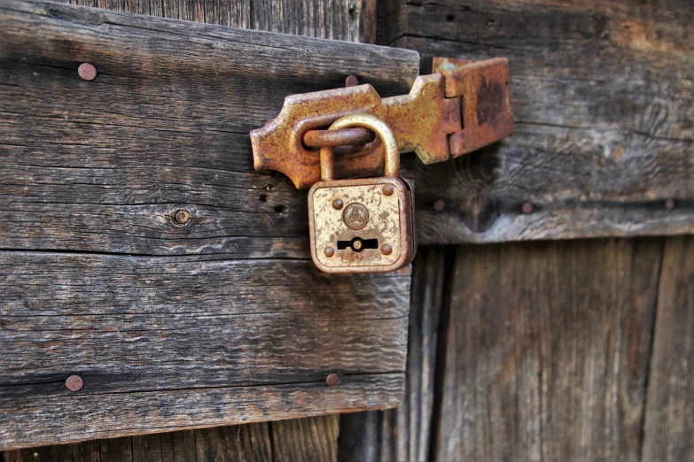 a close up of a padlock on a wooden door, a macro photograph, renaissance, 14th century, old bounty hanter, detailed surroundings, looking left