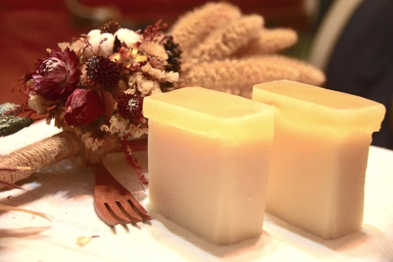 a couple of candles sitting on top of a table, by Rhea Carmi, soap, square, harvest, smooth color