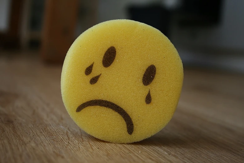 a yellow sponge with a sad face drawn on it, a picture, flickr, soft round face, with tears, ear, soft oval face