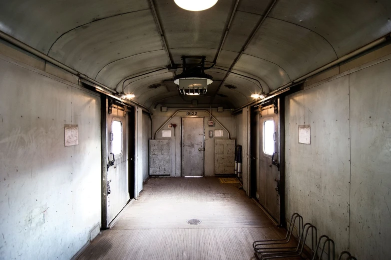 a long hallway with a bunch of chairs in it, by Richard Carline, shutterstock, an abandoned rusted train, inside large window of ship, a round minimalist behind, stock photo