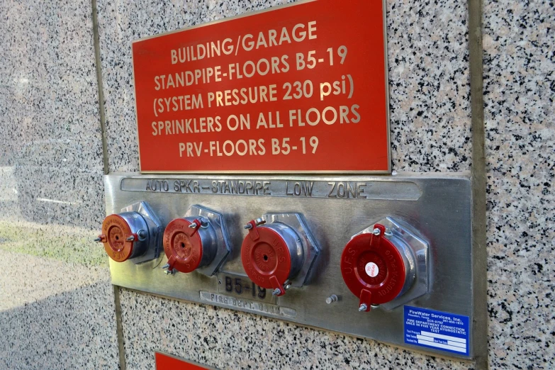 a fire hydrant mounted to the side of a building, a photo, flickr, control panels, in an underground parking garage, spangle, jpl