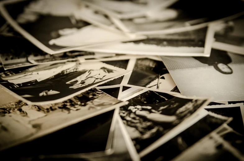a pile of old black and white photos, by Adam Chmielowski, unsplash, sepia colors, life story, professionally post - processed, istockphoto