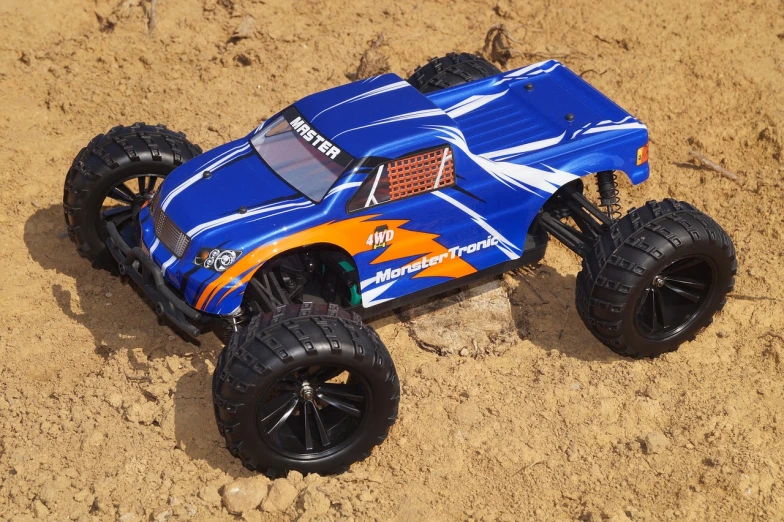 a toy truck that is sitting in the dirt, tumblr, strong blue and orange colors, hotoverse, car jumping, gmaster