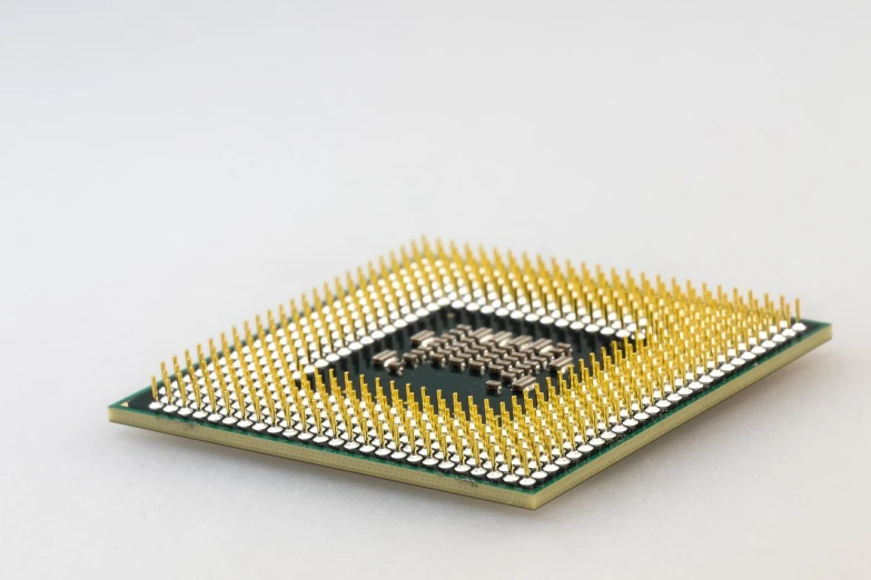 a close up of a computer chip on a white surface, pexels, raymarching, golden eal, product introduction photo, hypersharp