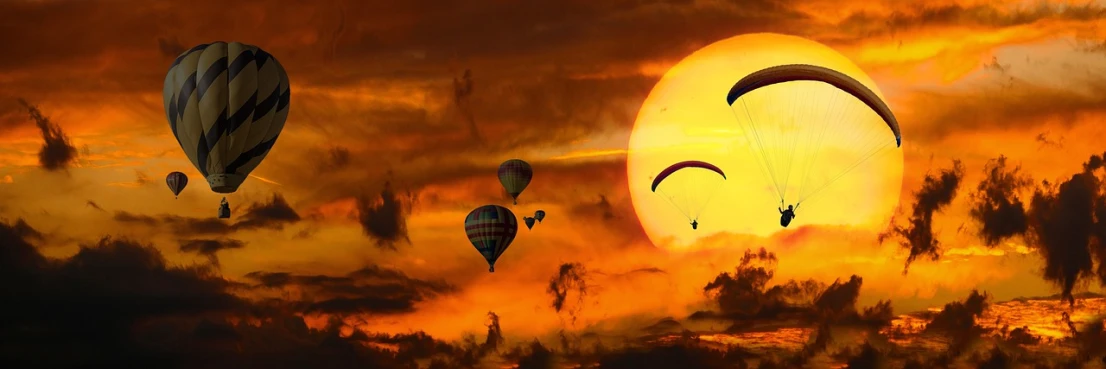 a group of hot air balloons flying in the sky, a picture, pixabay contest winner, romanticism, red sun over paradise, looking sad, cool marketing photo, yellow clouds