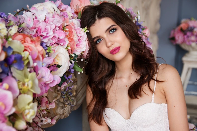 a woman posing in front of a bunch of flowers, by Maksimilijan Vanka, shutterstock, luxurious wedding, girl with dark brown hair, pink lips, groom